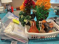 Basket with greeting cards, faux flowers, fall décor items