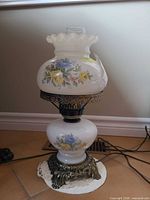 Full view of milk glass hurricane lamp showing base, globe, shade, and metal components