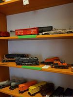 Three shelves with locomotives and freight cars