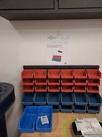 Rack mounted on wall with red and blue bins attached
