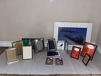 Group shot of all frames including large poster frame and assorted tabletop frames