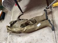 Full view of hip waders laid flat showing overall condition