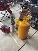 Propane torch kit box, portable air tank, battery charger and torch components grouped