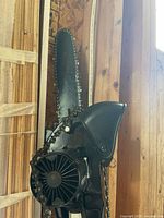 Chainsaw head with fan housing and chain visible