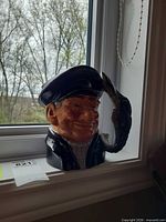 Front view of Royal Doulton Lobster Man character jug showing facial detail and lobster handle