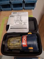 Laser level inside foam-padded case with manual