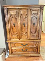 Full front view of armoire showing doors and drawers