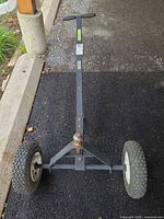 Full view of trailer dolly showing frame, handle and wheels
