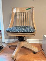 Front view of wooden banker swivel chair with cushion
