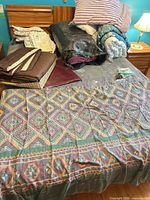 Overview of assorted bedding items spread on bed