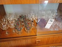 Cabinet shelf showing full assortment of glassware pieces