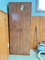 Closed cabinet front showing woodgrain finish and doors