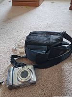 Camera, case, cable on carpet