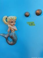 ceramic/plaster mermaid hook and two metal knobs mounted on wall