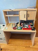Front view of desk and hutch showing cabinet, shelf, overall structure