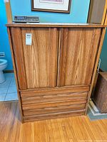 Front view of dresser showing closed cabinet doors and drawer fronts