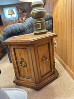 Closed view of hexagonal end table showing door and hardware