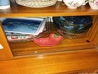 Assorted trays, bowls and pepper dish on shelf