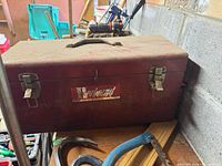Closed red Herbrand toolbox on workbench