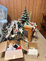 Group shot showing ceramic tree, wreath, candle holder, boxes of snowmen and ornaments