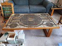 Full view of coffee table showing tile top pattern and wood frame