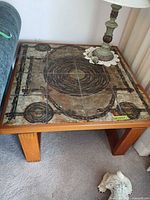 Overall view of square table showing ceramic tile top and wood legs