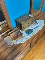 Overall shot of jewelry chest, vanity organizer and handheld mirror on dresser