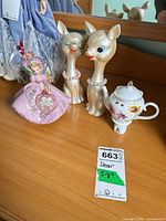 Group view of pink lady figurine, two deer heads, floral teapot night light