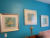 All three framed bird prints on wall