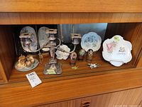 Full lot showing candelabra, plates, eggs, tea set, candles, brooch