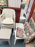 Stack of chairs, tables, cushions and pillow