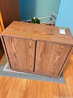 Front view of wood-grain laminate cabinet on small rug