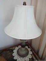 Full lamp with shade on table