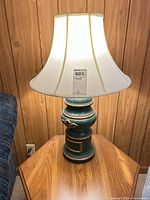 Full view of lamp on table showing body and shade