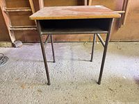 front view showing storage shelf and metal legs