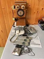 All phones, handsets, cradles, cords and manuals displayed on table