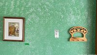 Framed print and cat welcome rack on wall
