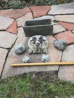 all six garden decor pieces arranged with yardstick for scale