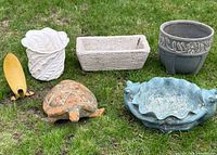 All six garden pieces grouped on grass