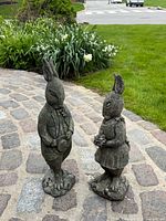 Front view of both rabbit statues on stone path