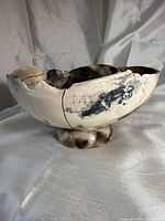 Right front view of raku pedestal bowl showing fractured gold seams and smoke-fired finish