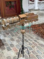 Side view of train weathervane on stand showing overall form and patina