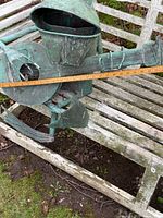 Frog sculpture length measured across instrument showing verdigris copper and weathering