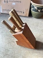 Side view of knife block showing wood handles and block