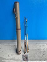 Overall view of two fly rods, rod tube and closed fly box