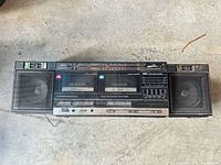 Front view of JVC PC-W47 boombox showing speakers, dual cassette decks and control panel