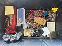 Overview of entire lot inside tote showing binoculars, jewelry pieces and boxes