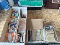 Overall view of three-row box, tuck box and plastic bin filled with cards