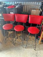 Three red barstools front view