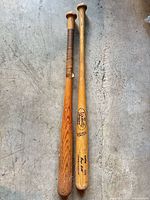 Full view of both bats side by side, showing relative color, length and taped grip